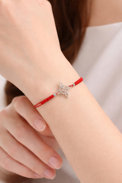 AeraVida Adjustable Red Witches Knot Bracelet with Sterling Silver Flower Charm – 19mm Symbol Centerpiece, Cotton Rope Band 6 to 9 Inches, Sliding Knot Closure
