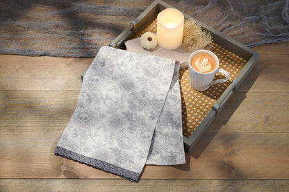 Primitives by Kathy Decorative Kitchen Towel, from Our Halloween Collection displays a Spooky Monochrome Pattern of Skull Flowers and Roses with a complementing Gray lace Trim