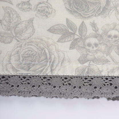 Primitives by Kathy Decorative Kitchen Towel, from Our Halloween Collection displays a Spooky Monochrome Pattern of Skull Flowers and Roses with a complementing Gray lace Trim